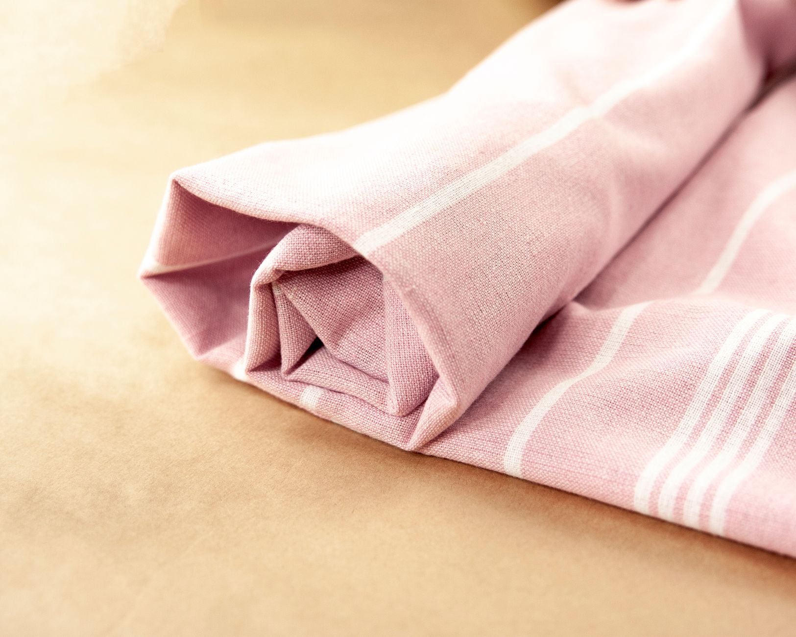 Close-up of a folded striped towel highlighting soft, absorbent cotton texture.
